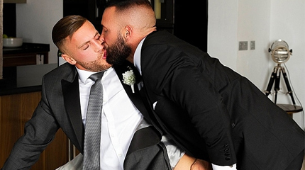 The best man helps put some final touches on the grooms suit